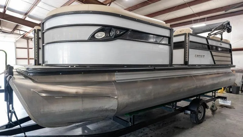 Slide: The Image of 2021 Crest Classic Platinum 220 SLSC pontoon boat in a storage facility. - 3