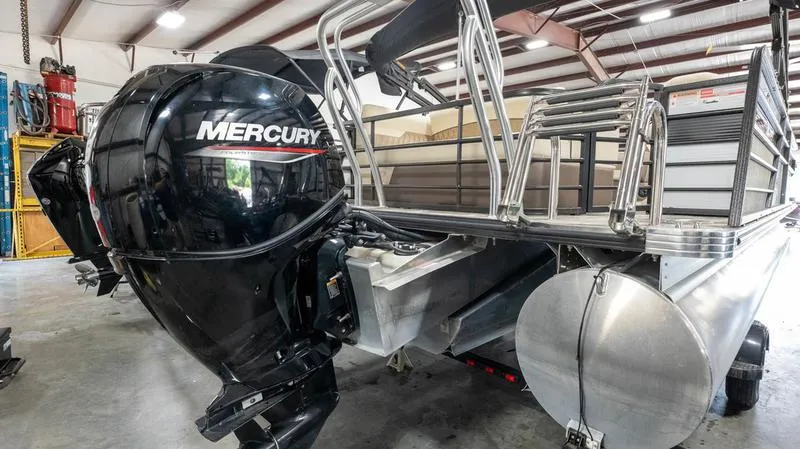 Slide: The Image of 2021 Crest Classic Platinum 220 SLSC pontoon boat with Mercury outboard motor in a warehouse. - 32