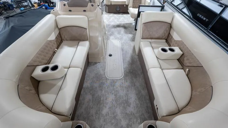 Slide: The Image of 2021 Crest Classic Platinum 220 SLSC boat interior with beige seating and cup holders. - 7