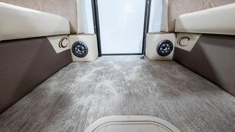 Slide: The Image of Interior of 2021 Crest Classic Platinum 220 SLSC pontoon boat with carpeted flooring and built-in speakers. - 9