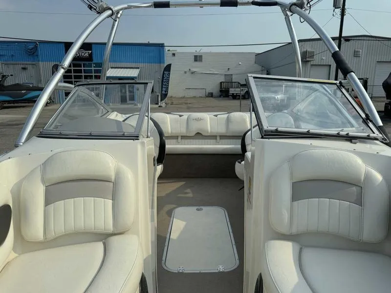 Slide: The Image of 2008 Stingray 195 LX boat interior with white leather seats and open windshield. - 13