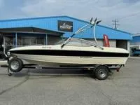 Slide: The Image of 2008 Stingray 195 LX boat on trailer outside blue building. - 14