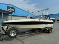 Slide: The Image of 2008 Stingray 195 LX boat on trailer outside blue building. - 15