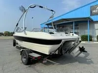 Slide: The Image of 2008 Stingray 195 LX boat on trailer outside blue building. - 17