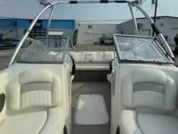 Slide: The Image of 2008 Stingray 195 LX boat interior with white seating and open windshield. - 25
