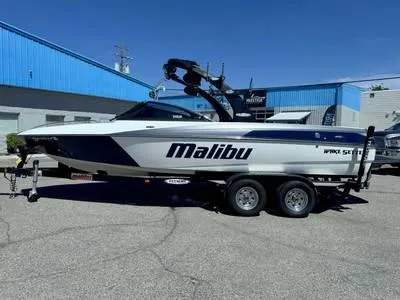 Slide: The Image of 2008 Stingray 195 LX boat on trailer in front of blue building. - 29