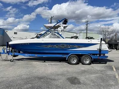 Slide: The Image of 2008 Stingray 195 LX boat on a blue trailer under a partly cloudy sky. - 30