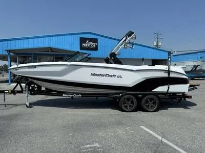 Slide: The Image of 2008 Stingray 195 LX boat on trailer in front of blue building - 32
