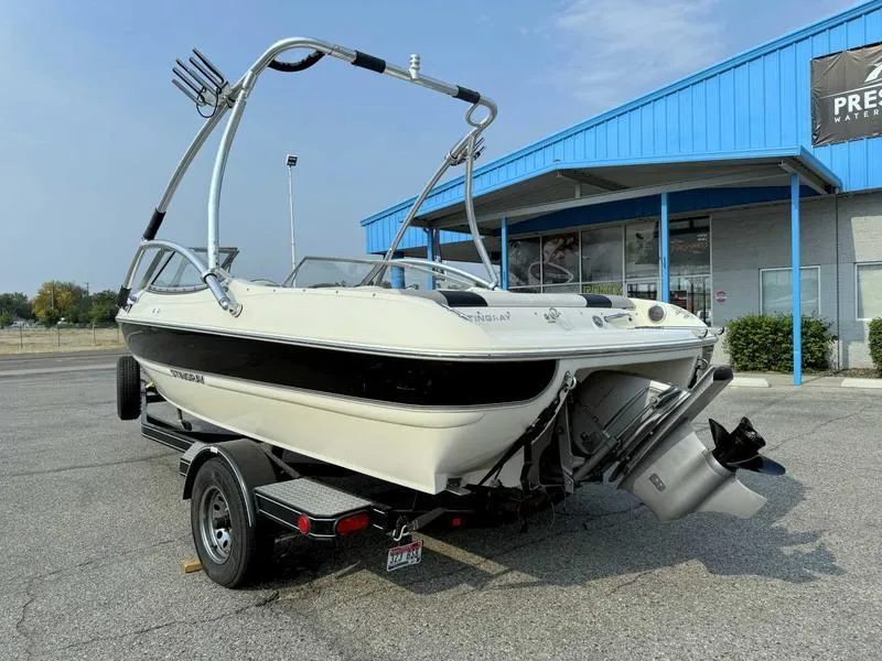Slide: The Image of 2008 Stingray 195 LX boat on trailer, parked outside a blue building. - 5