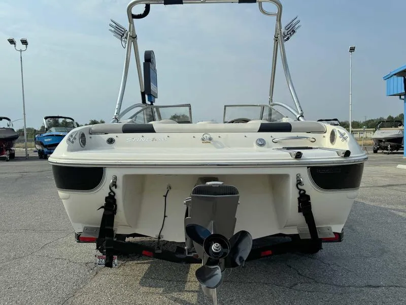 Slide: The Image of 2008 Stingray 195 LX boat rear view with outboard motor in a parking lot. - 7