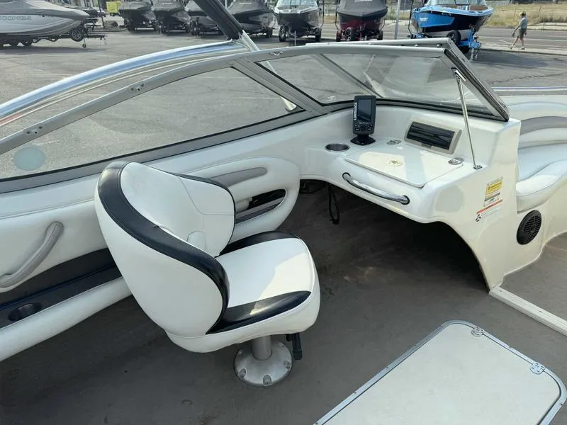 Slide: The Image of 2008 Stingray 195 LX boat interior with captain's chair and dashboard. - 9