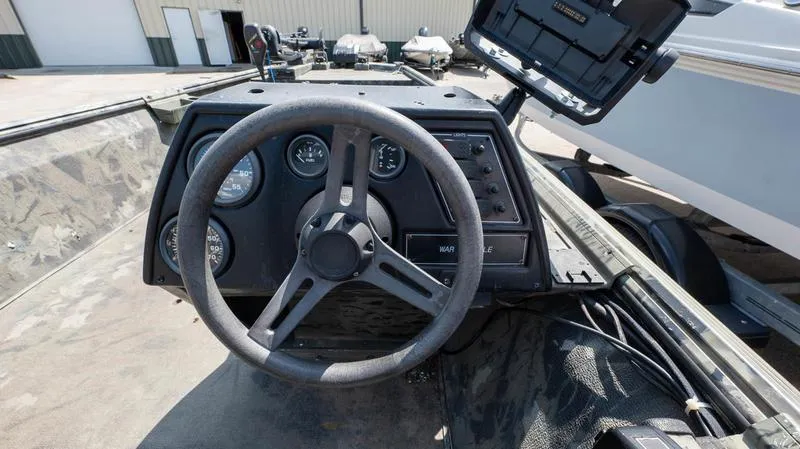 Slide: The Image of 2003 War Eagle 754 LDSV boat dashboard with steering wheel and gauges. - 11