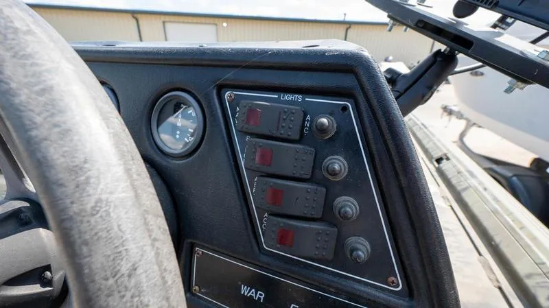 Slide: The Image of Control panel of a 2003 War Eagle 754 LDSV boat with light switches. - 13