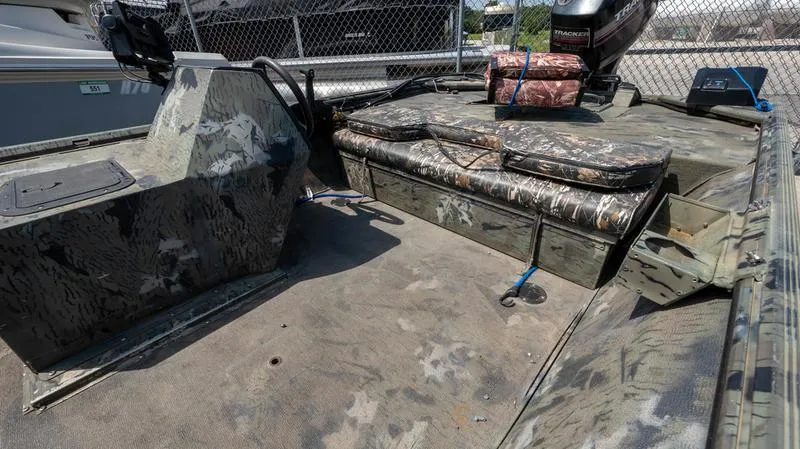 Slide: The Image of 2003 War Eagle 754 LDSV boat interior with camouflage seating and storage. - 18