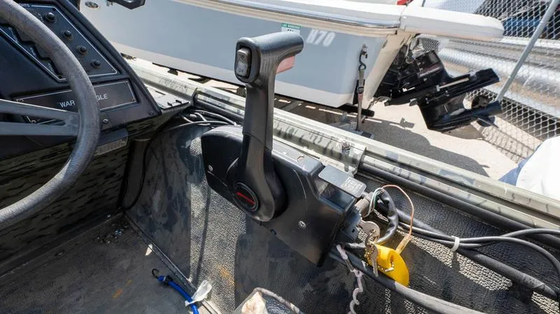 Slide: The Image of 2003 War Eagle 754 LDSV boat throttle control and dashboard. - 24
