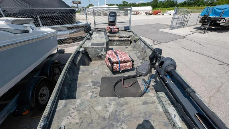 Slide: The Image of 2003 War Eagle 754 LDSV boat with camouflage interior, parked in a lot. - 7