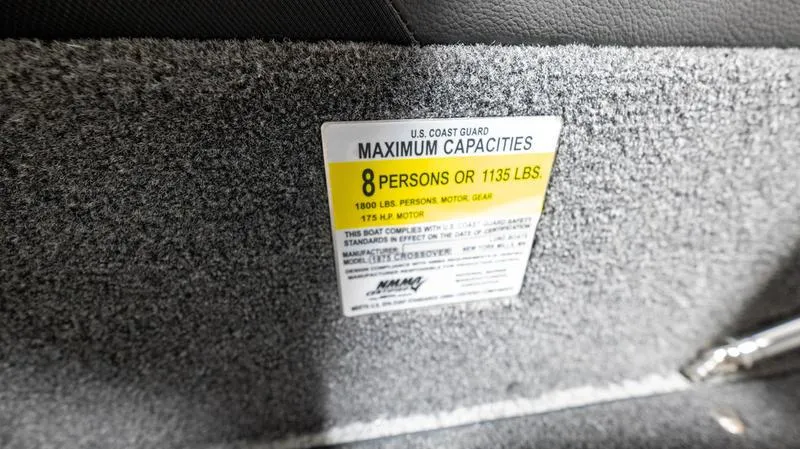 Slide: The Image of 2024 Lund 1875 Crossover XS capacity label, maximum 8 persons or 1135 lbs. - 12