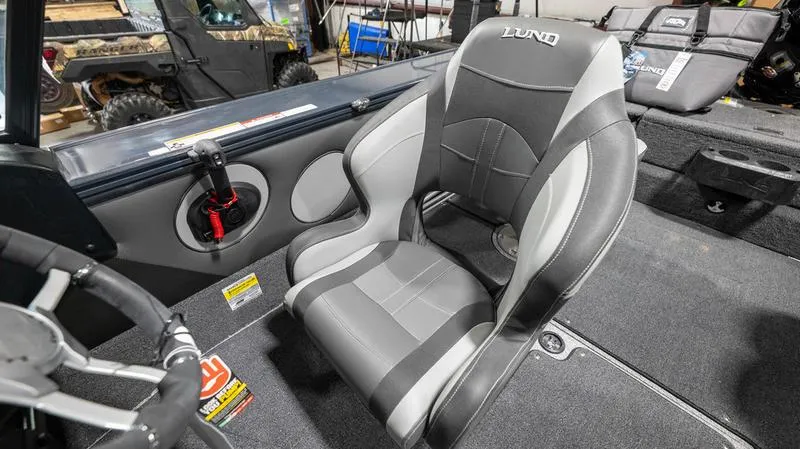Slide: The Image of 2024 Lund 1875 Crossover XS boat interior with gray and black seating. - 13