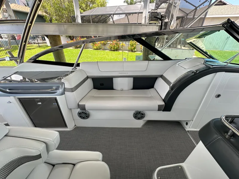 Slide: The Image of 2015 Formula 350 CBR boat interior with white and gray seating. - 13