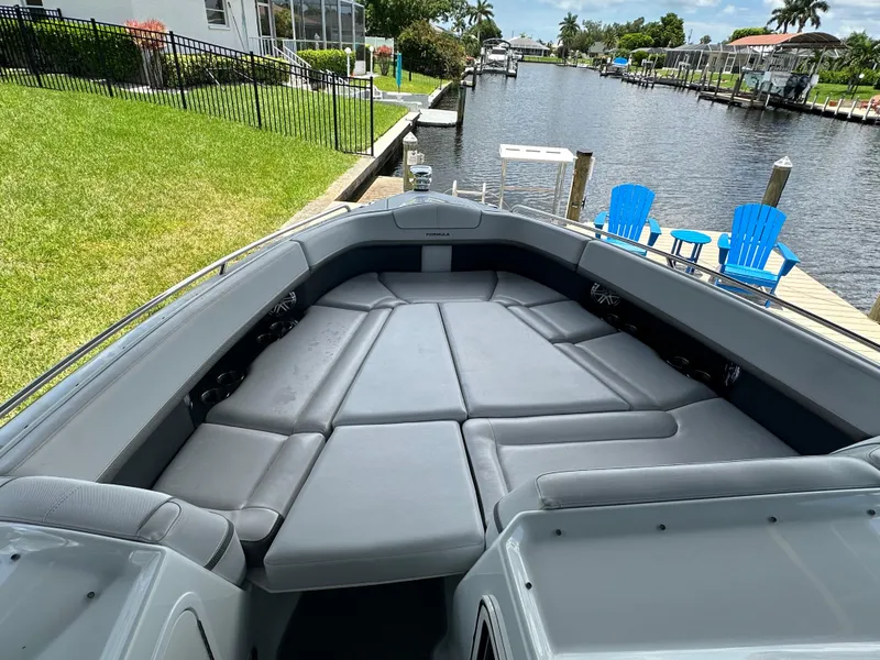 Slide: The Image of 2015 Formula 350 CBR boat with spacious bow seating docked by a canal. - 14