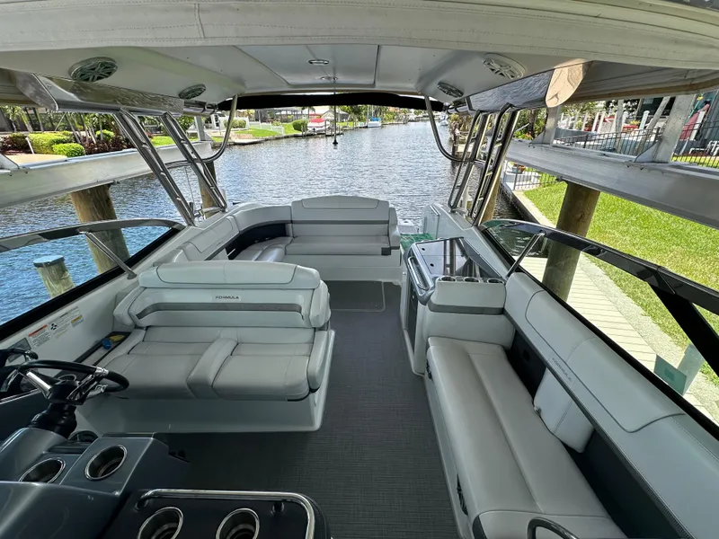 Slide: The Image of 2015 Formula 350 CBR boat interior with spacious seating and waterfront view. - 16