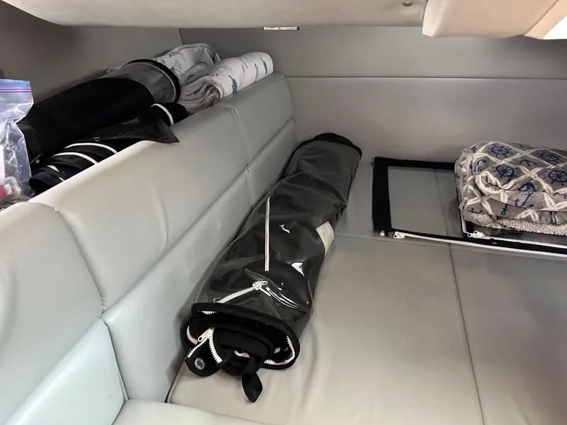Slide: The Image of Interior storage area of a 2015 Formula 350 CBR boat with rolled-up covers. - 19