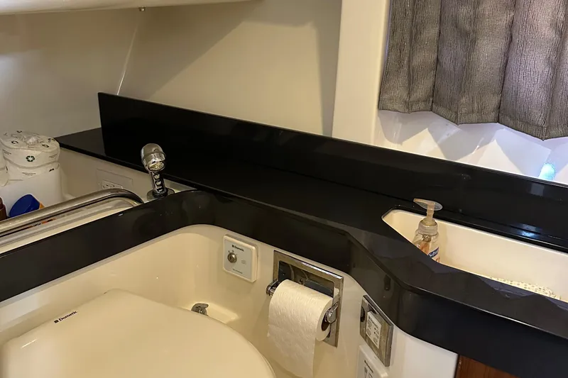 Slide: The Image of 2015 Formula 350 CBR bathroom with black countertop and modern fixtures. - 23