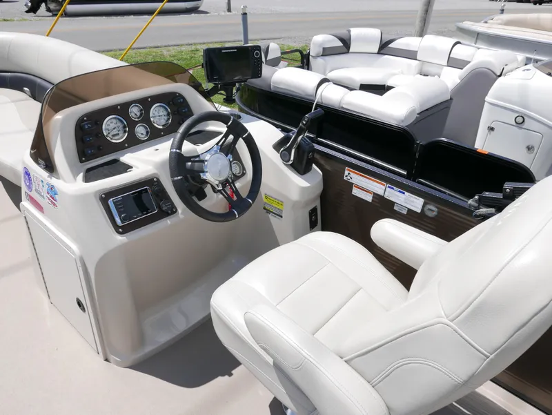 Slide: The Image of 2019 Manitou 23 Aurora VP boat interior with steering console and seating. - 5