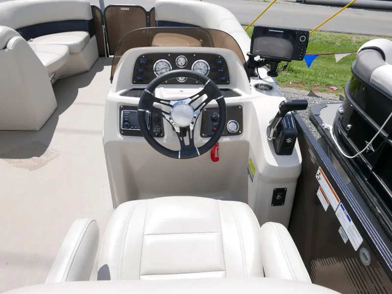 Slide: The Image of 2019 Manitou 23 Aroura VP boat cockpit with steering wheel and control panel. - 6