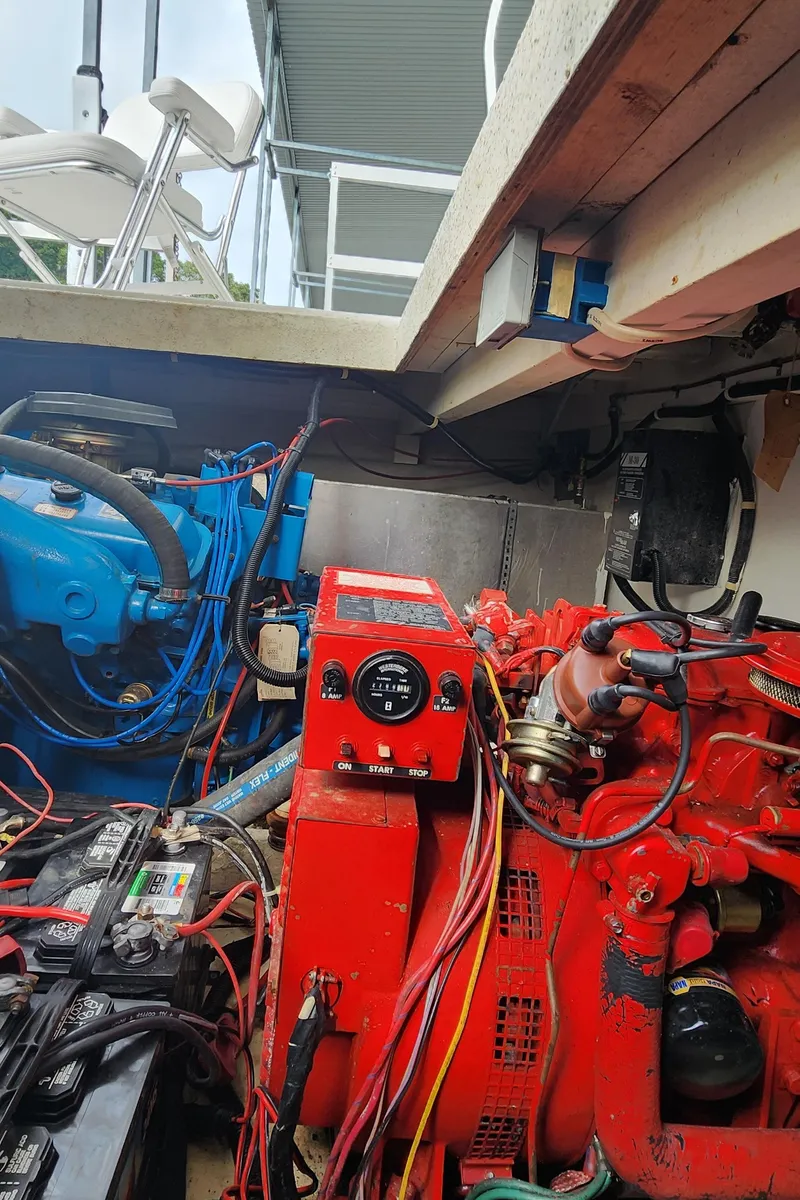 Slide: The Image of Engine compartment of a 1993 Gibson 50 Cabin Yacht showing red and blue engines. - 10