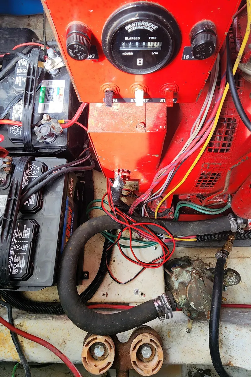 Slide: The Image of Engine compartment of a 1993 Gibson 50 Cabin Yacht with batteries and wiring. - 11