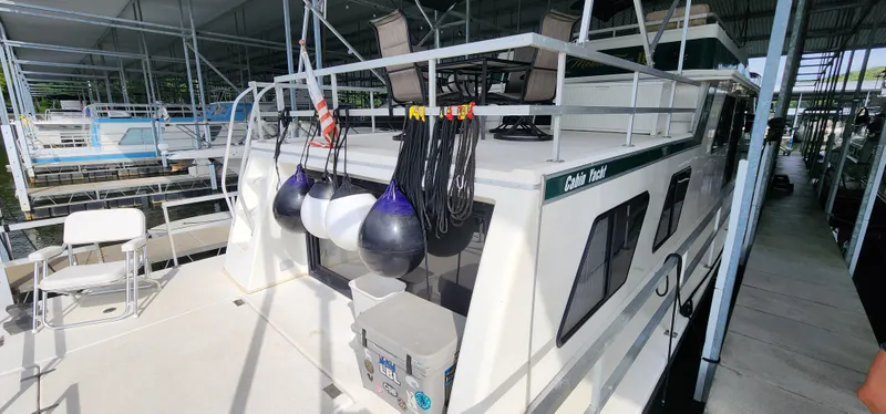 Slide: The Image of 1993 Gibson 50 Cabin Yacht docked in a marina, rear view. - 12