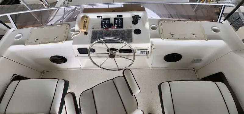Slide: The Image of Cockpit of a 1993 Gibson 50 Cabin Yacht with steering wheel and control panel. - 13