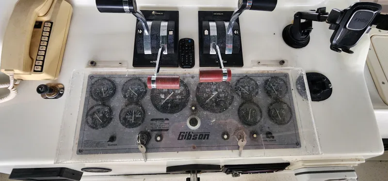 Slide: The Image of Control panel of a 1993 Gibson 50 Cabin Yacht with throttle levers and gauges. - 14