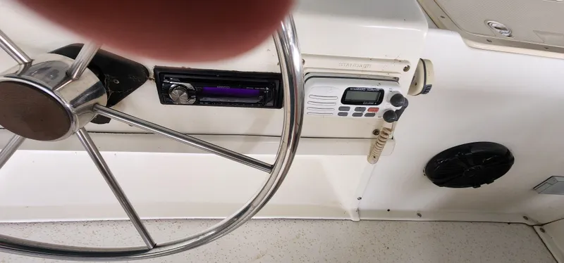 Slide: The Image of Steering wheel and control panel of a 1993 Gibson 50 Cabin Yacht. - 15