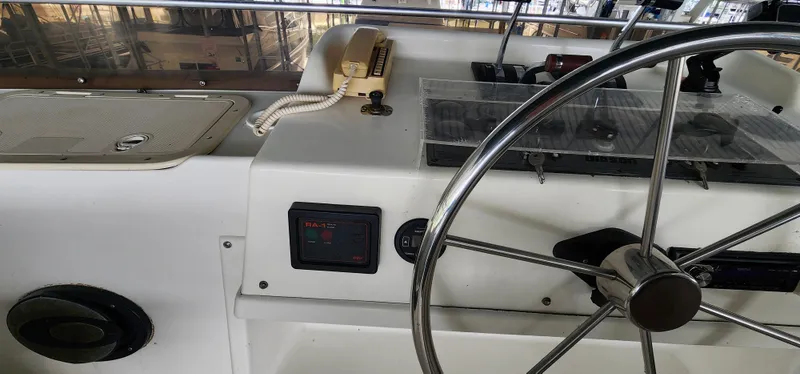 Slide: The Image of Control panel of a 1993 Gibson 50 Cabin Yacht with steering wheel. - 16