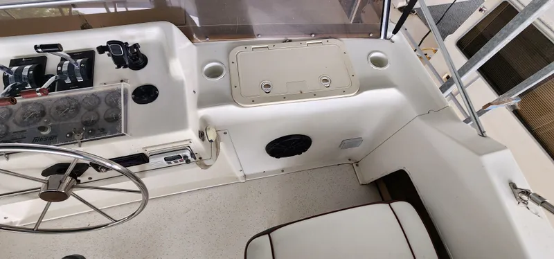 Slide: The Image of 1993 Gibson 50 Cabin Yacht helm with steering wheel and control panel. - 17