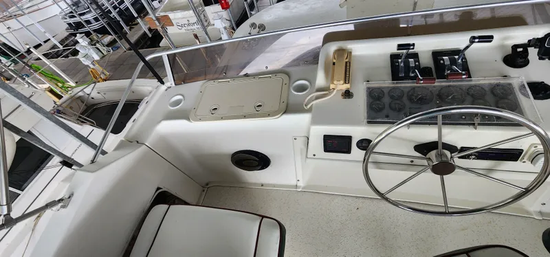 Slide: The Image of Control panel of a 1993 Gibson 50 Cabin Yacht with steering wheel and navigation instruments. - 18