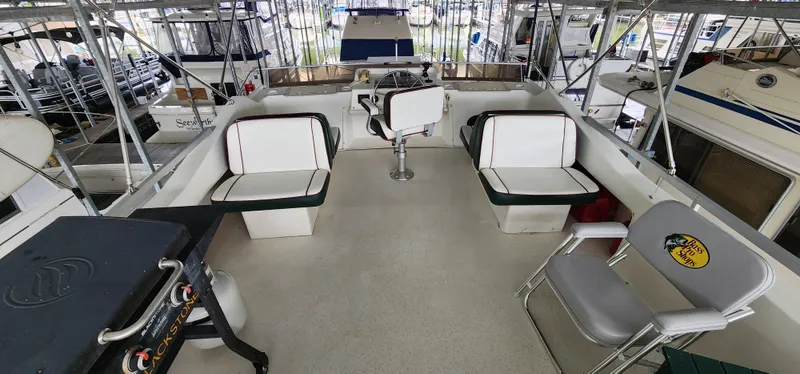Slide: The Image of 1993 Gibson 50 Cabin Yacht interior with seating and steering area. - 21