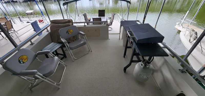 Slide: The Image of 1993 Gibson 50 Cabin Yacht deck with chairs and grill. - 22