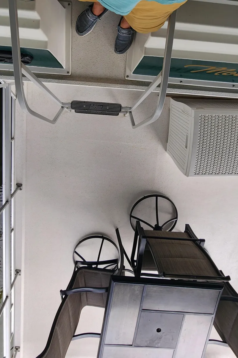 Slide: The Image of 1993 Gibson 50 Cabin Yacht deck with outdoor furniture and air conditioning unit. - 27