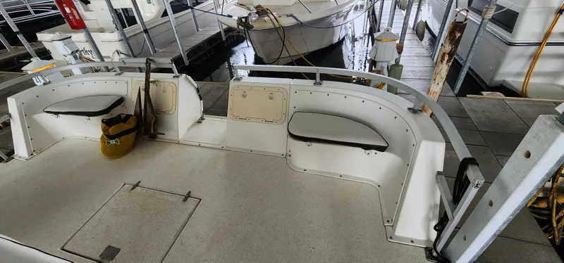 Slide: The Image of 1993 Gibson 50 Cabin Yacht stern view with seating and storage compartments. - 28