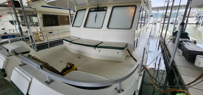 Slide: The Image of 1993 Gibson 50 Cabin Yacht docked, featuring spacious rear deck with seating. - 29