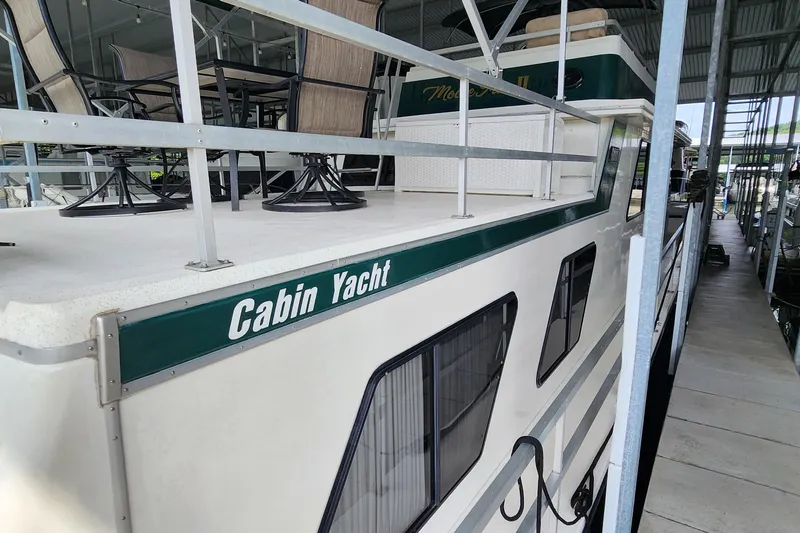 Slide: The Image of 1993 Gibson 50 Cabin Yacht docked in a marina, side view. - 30