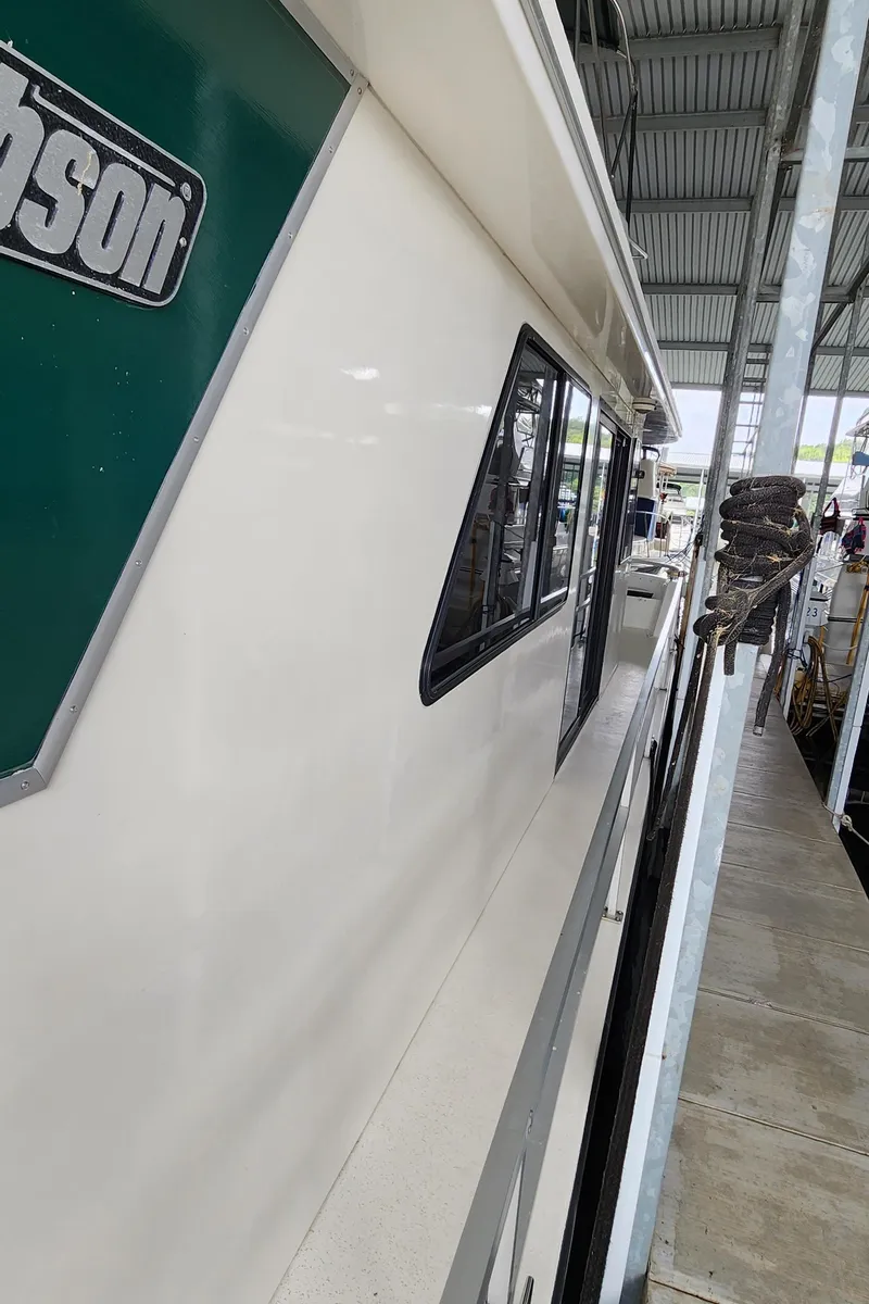 Slide: The Image of 1993 Gibson 50 Cabin Yacht docked in a covered marina. - 31