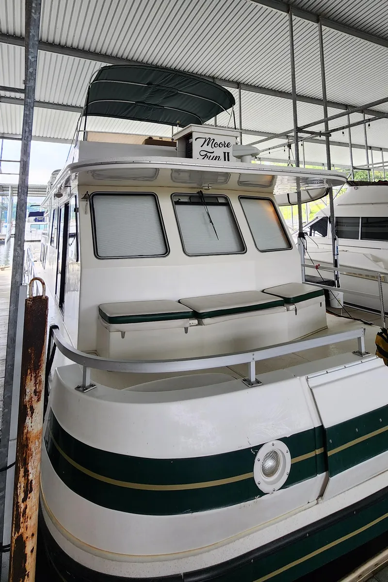 Slide: The Image of 1993 Gibson 50 Cabin Yacht docked in a covered marina. - 34