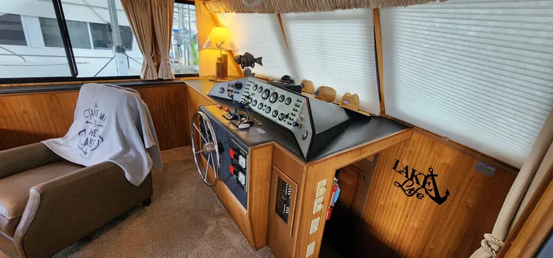 Slide: The Image of Interior helm of a 1993 Gibson 50 Cabin Yacht with wooden paneling and control console. - 35