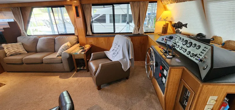 Slide: The Image of Interior of a 1993 Gibson 50 Cabin Yacht with sofa, armchair, and control panel. - 36