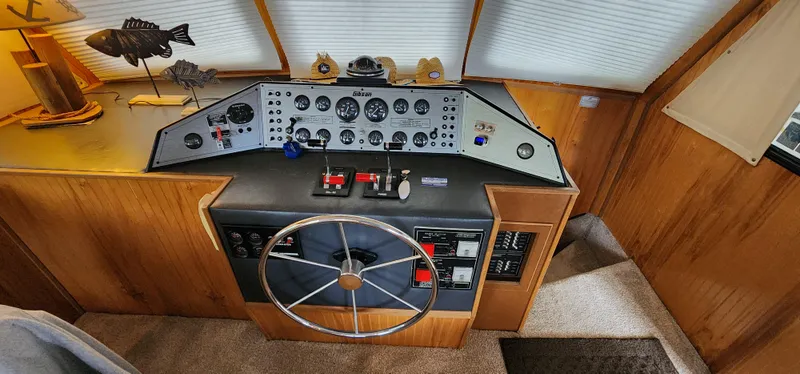 Slide: The Image of 1993 Gibson 50 Cabin Yacht helm with steering wheel and control panel. - 37