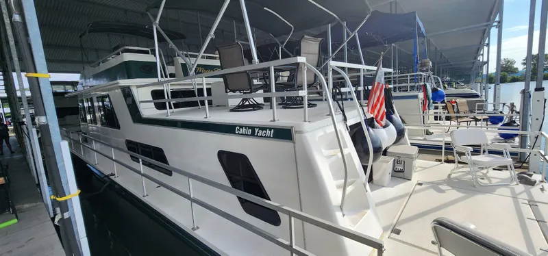Slide: The Image of 1993 Gibson 50 Cabin Yacht docked in a marina, side view. - 4